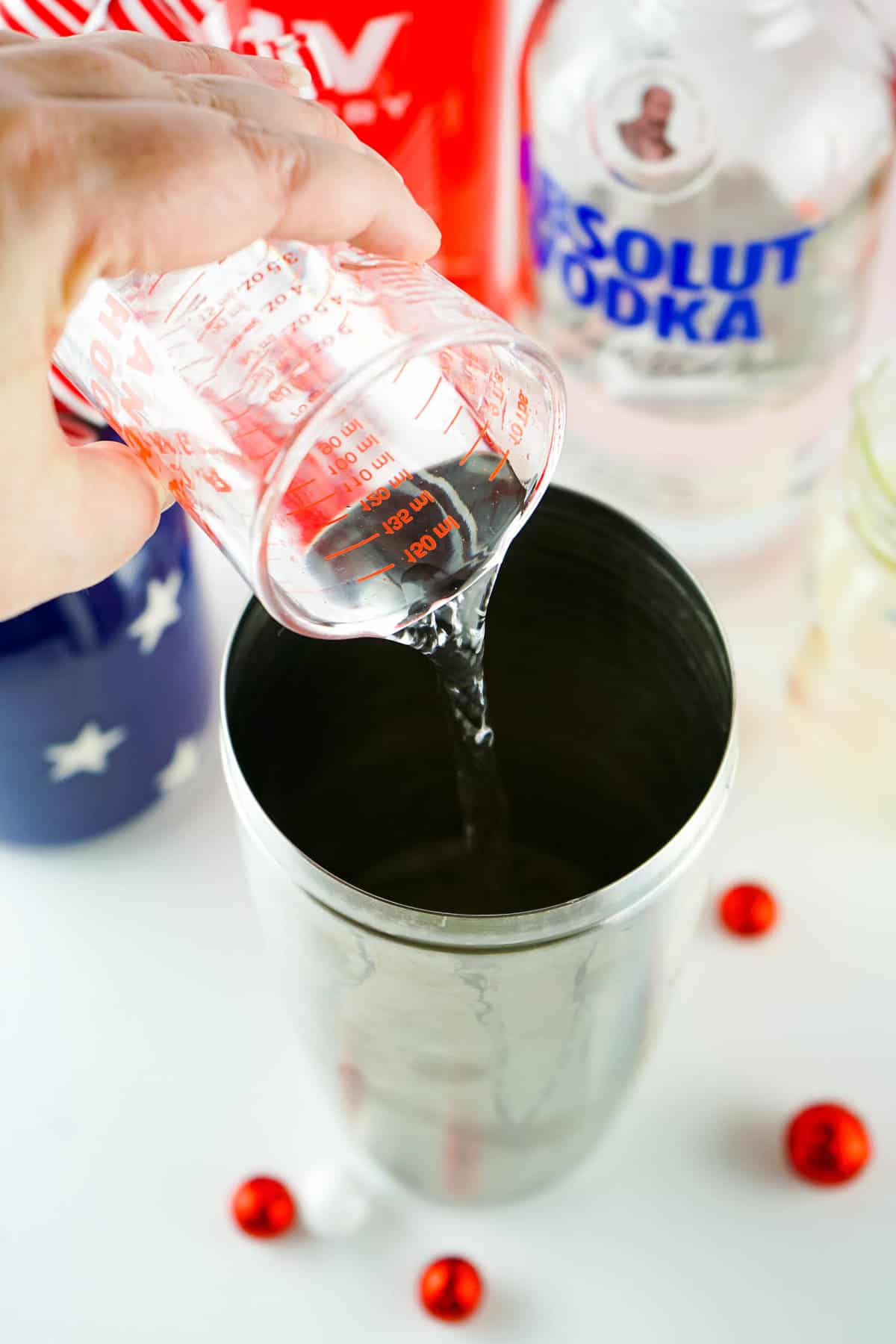 Adding vodka to lemonade in shaker for Red, White and Blue Cocktail
