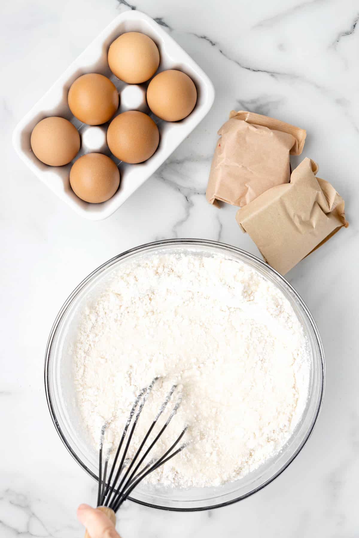 Whisking white cake mix per box instructions for  4th of July Poke Cake Recipe