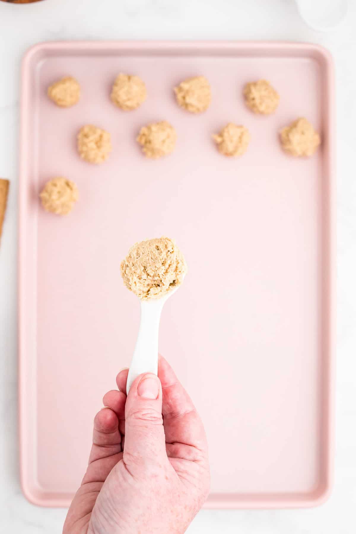 Use 1 tablespoon of the mixture and roll in a ball a place on the cookie sheet.