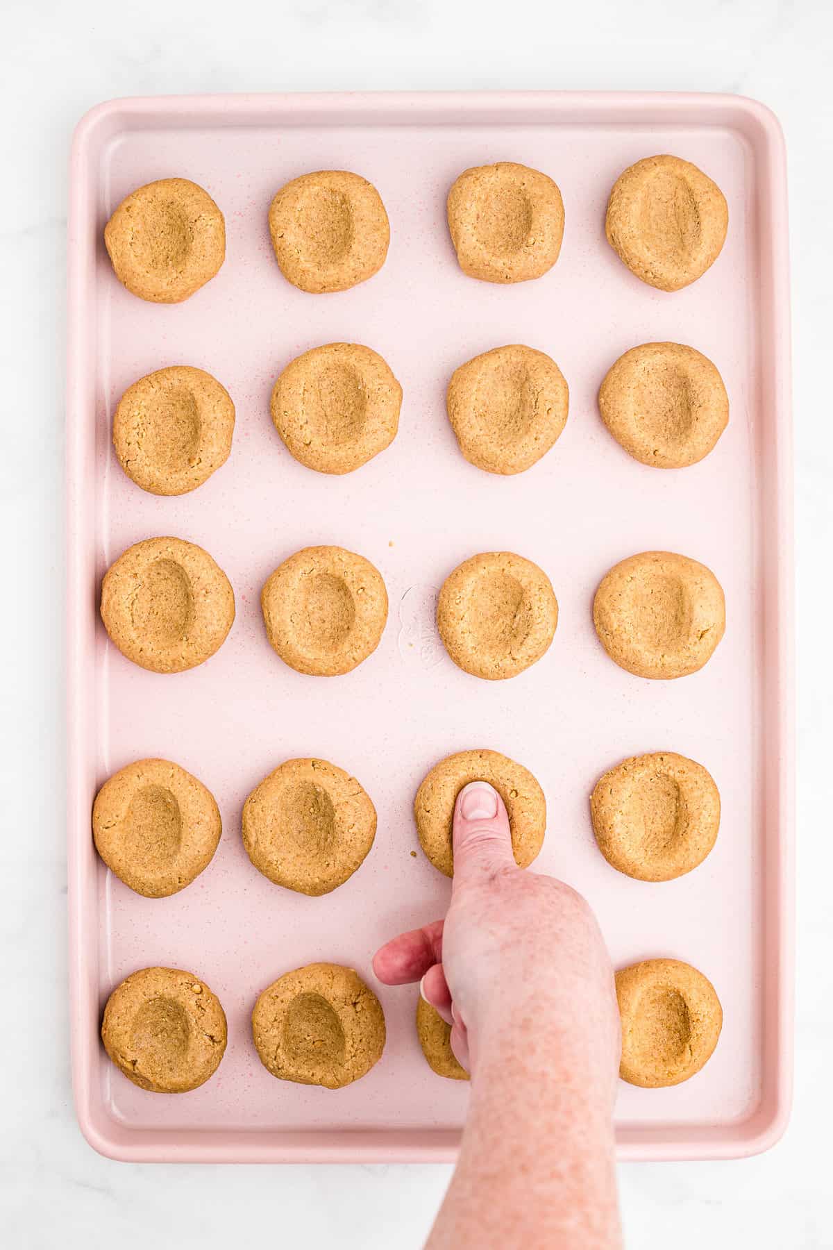 Push a thumbprint in each of the cookie balls. Bake cookies for 10 minutes