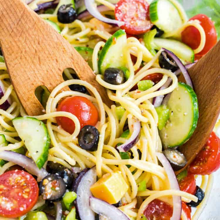 Spaghetti Salad loaded with flavor tossed in bowl with a wooden spoon