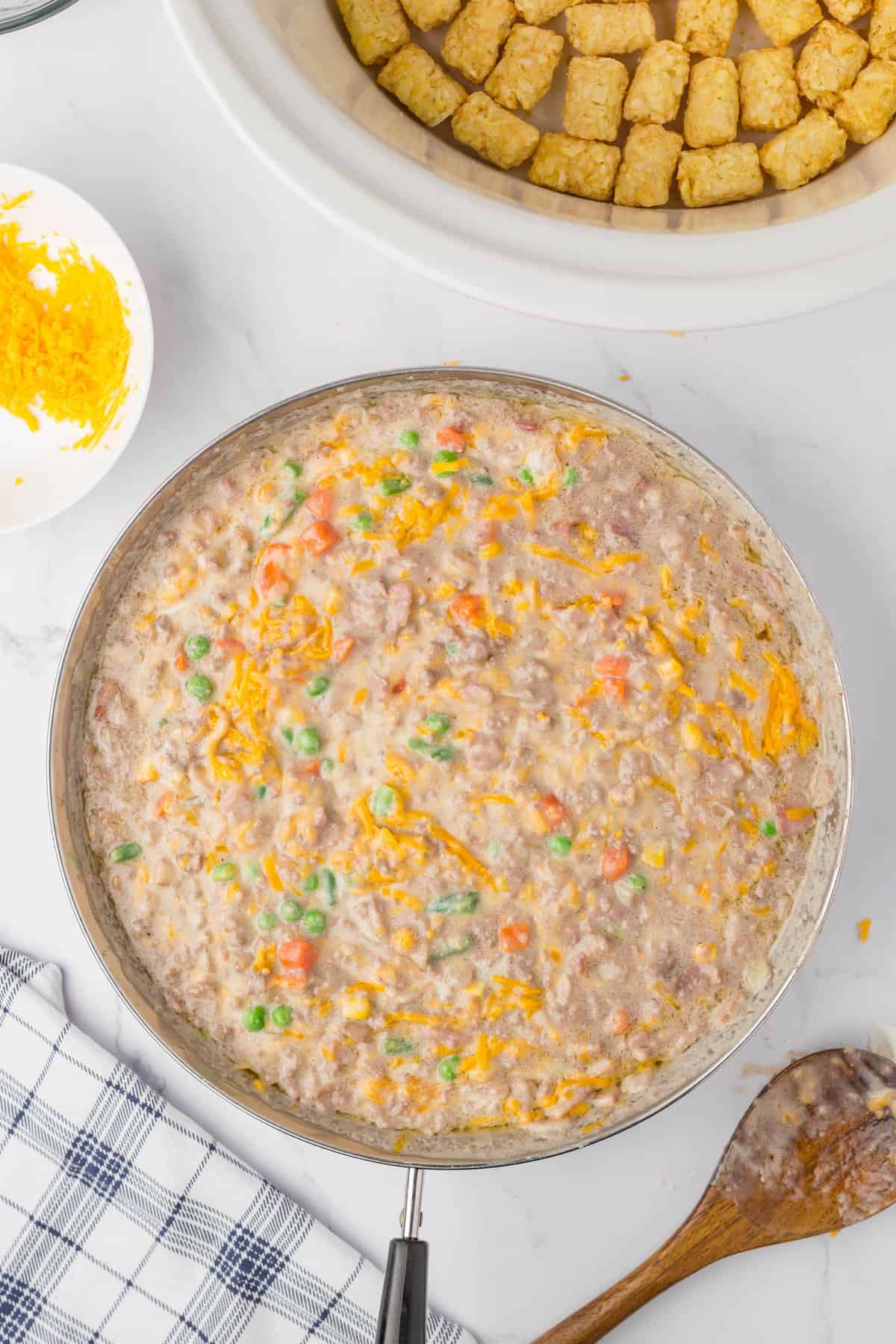 Mixed ingredients for for Bacon Cheeseburger Crock Pot Tater Tot Casserole recipe