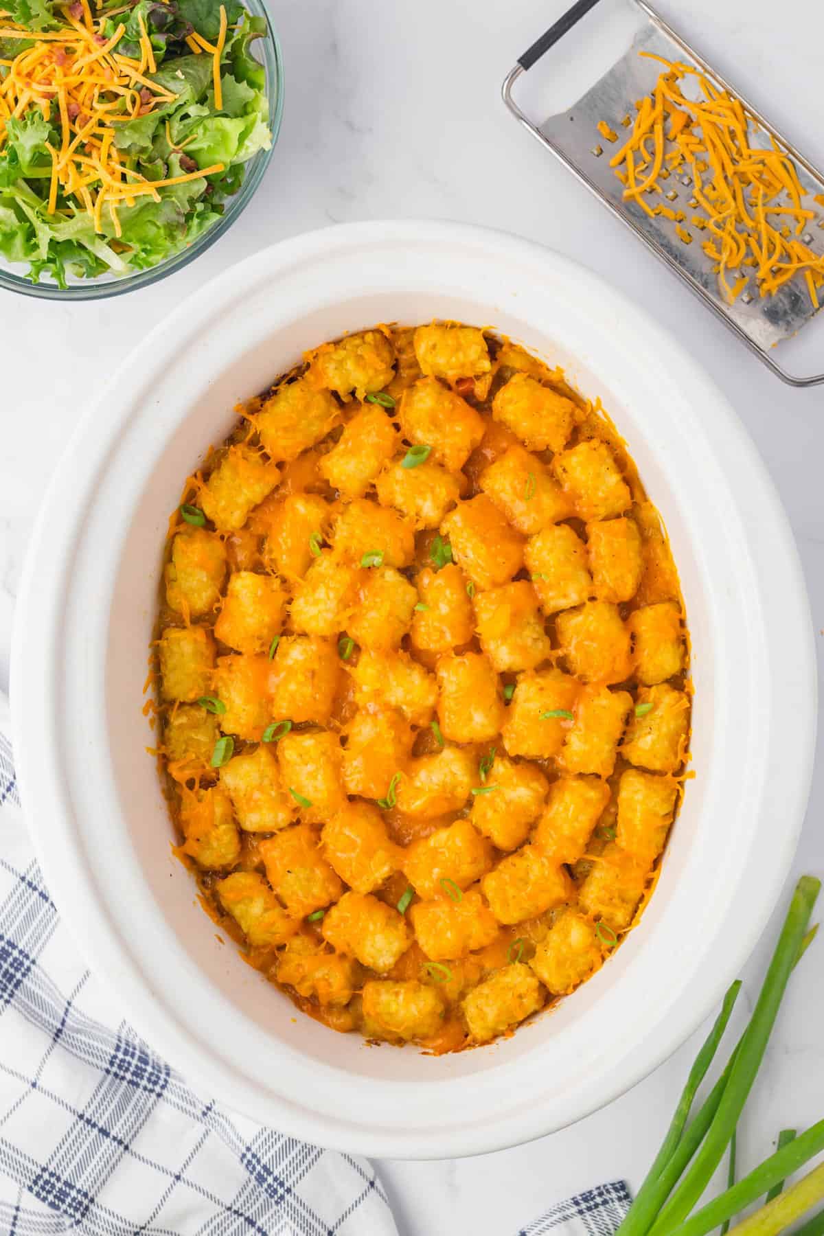 Topping Bacon Cheeseburger Crock Pot Tater Tot Casserole ingredients with cheese