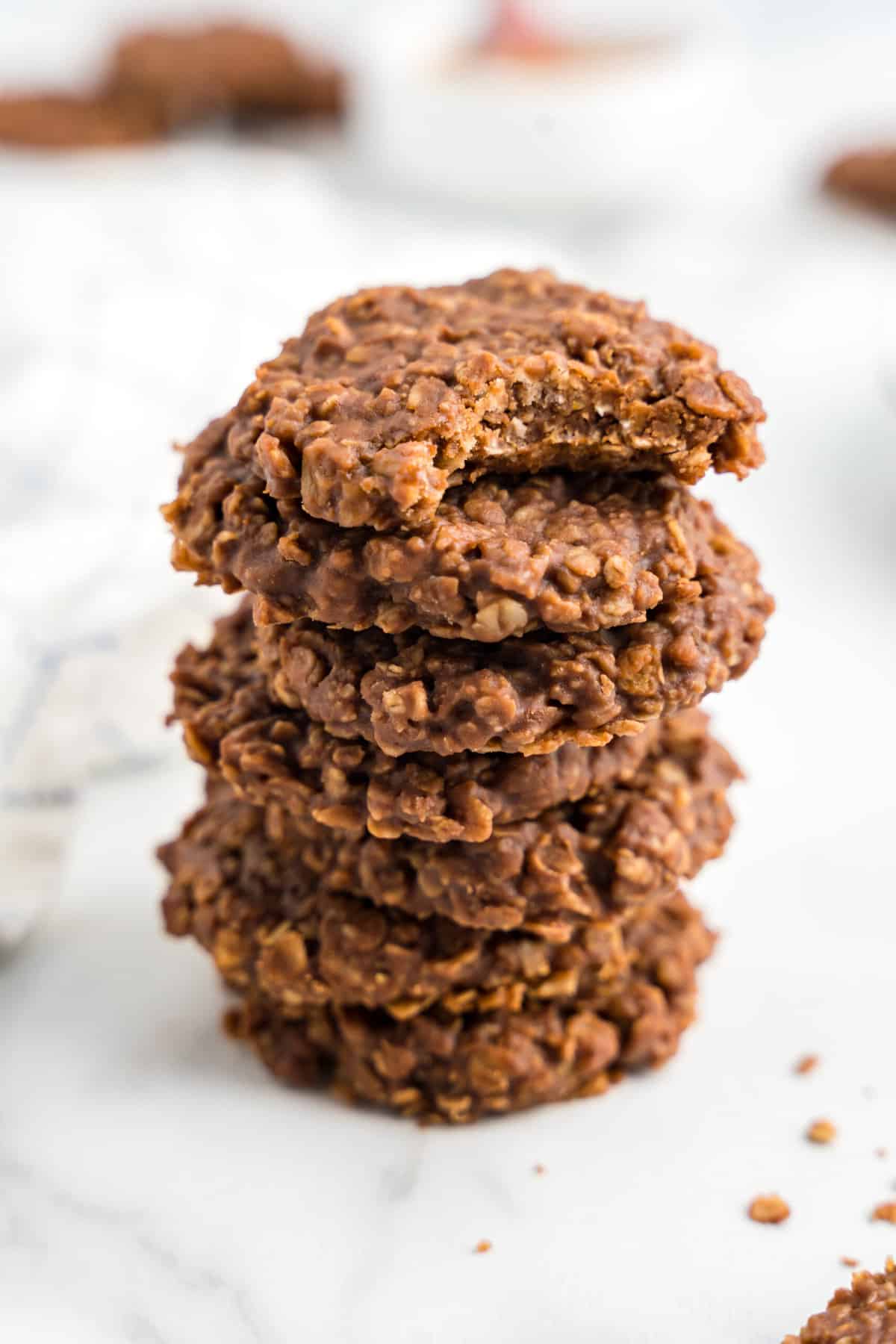 Close up Stack of No Bake Cookies with a bite Taken out of the Top one.