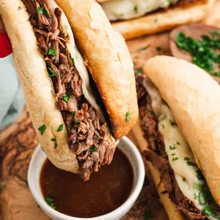 French Dip Sandwich dipping in au jus.