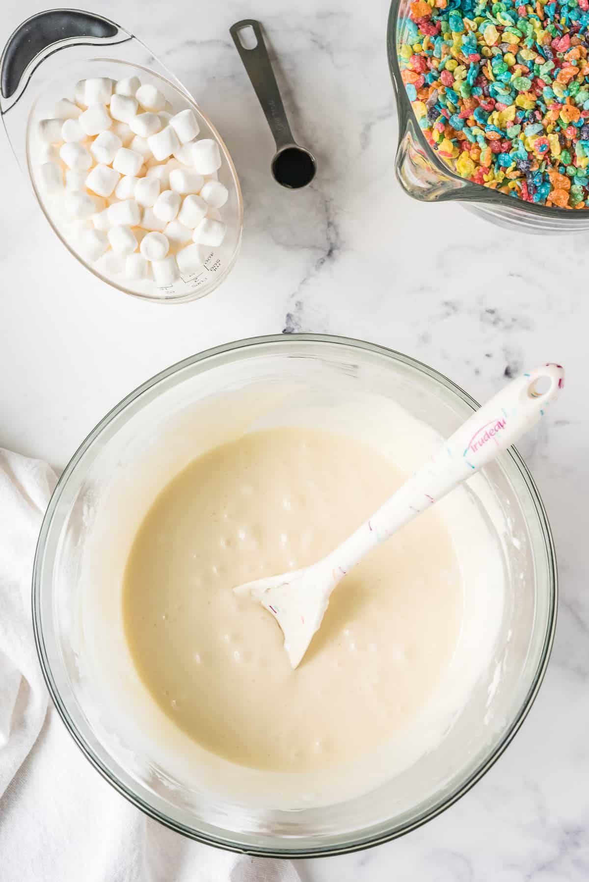 Stir together Melted Butter and Marshmallows until smooth.