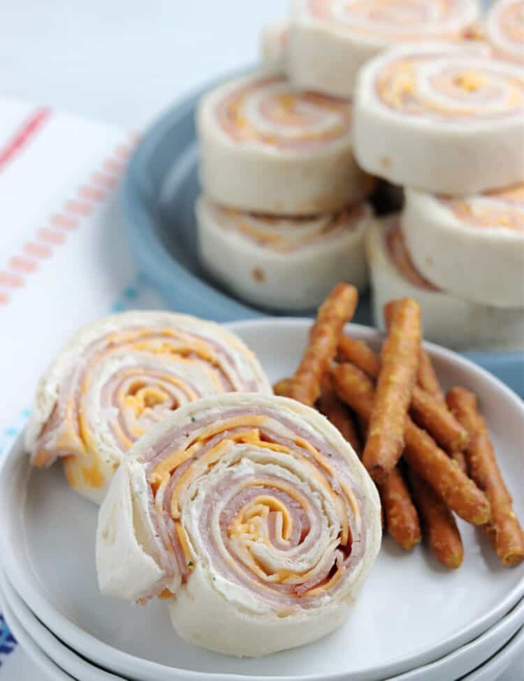 Cut up Rollups with Pretzels on the side on a plate.