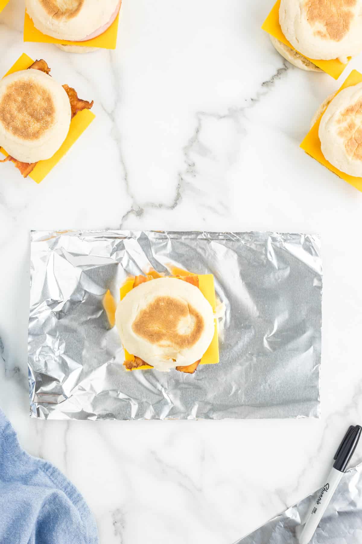 Placing Frozen Breakfast Sandwiches in tin foil