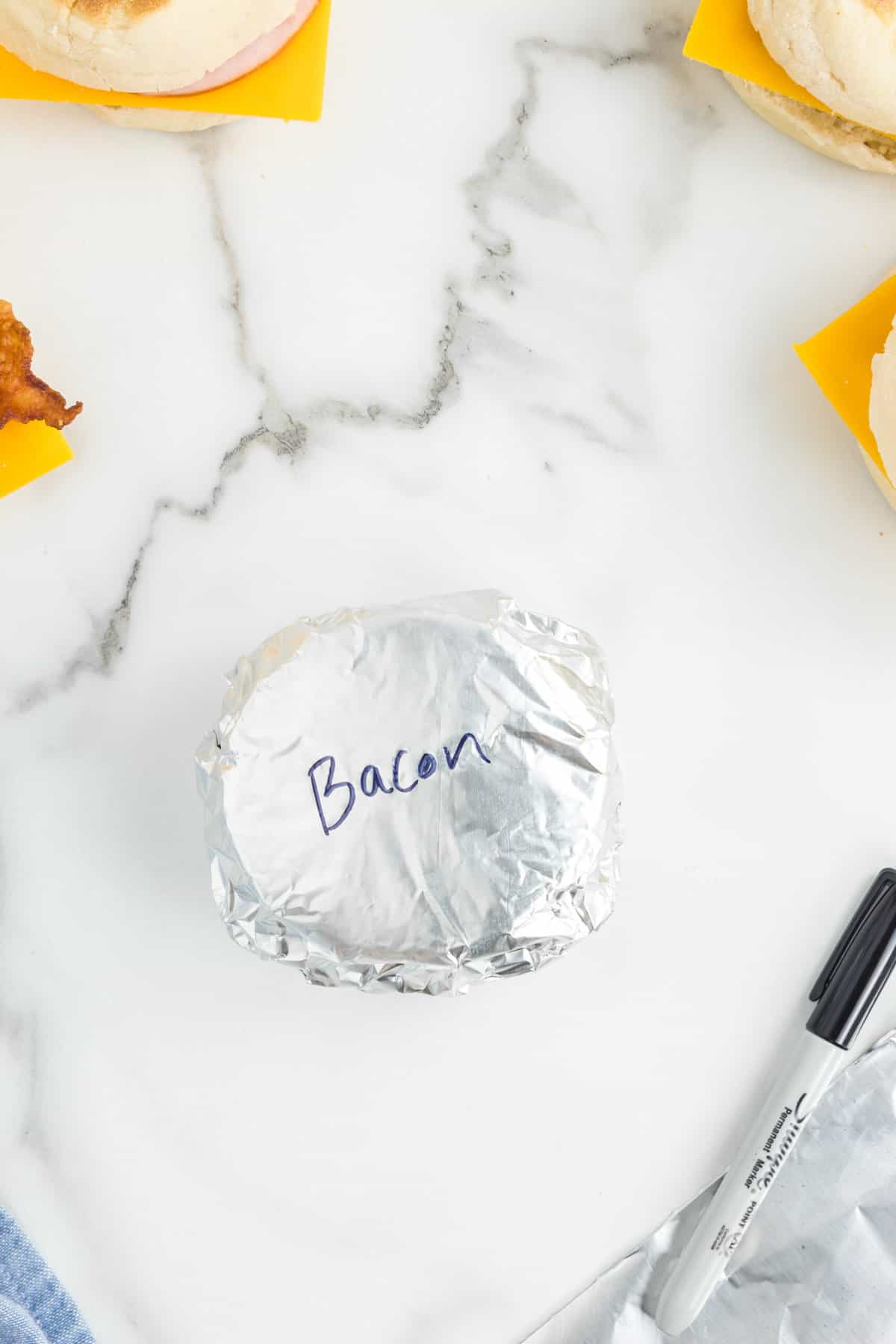 Labeling Tinfoil Make Ahead Breakfast Sandwiches with Sharpie Marker