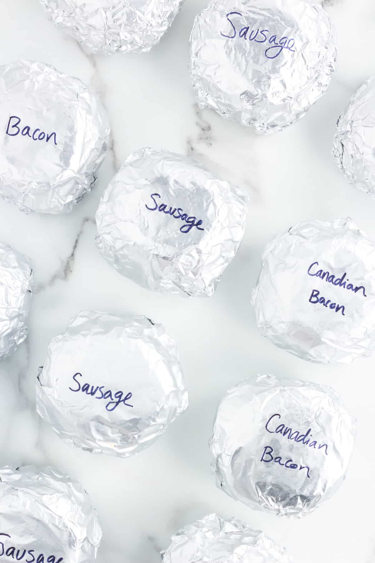 Labeling Tinfoil Make Ahead Breakfast Sandwiches with Sharpie Marker