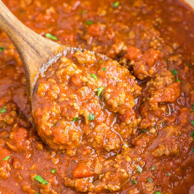 Homemade Spaghetti Sauce Recipe in Stovetop Pot with Wooden Spoon Stirring