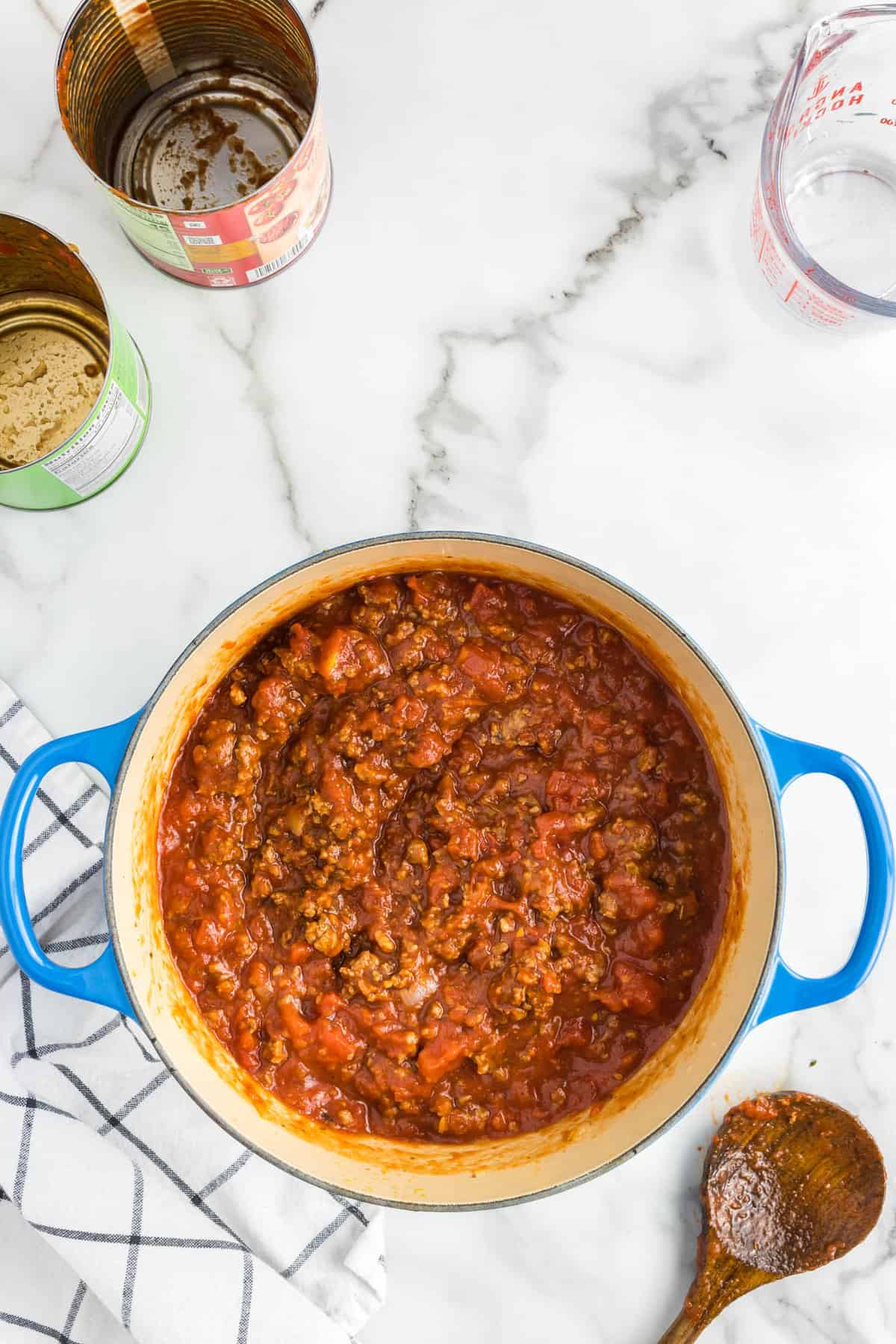 Seasoned meat with tomatoes in pot for Homemade Spaghetti Sauce