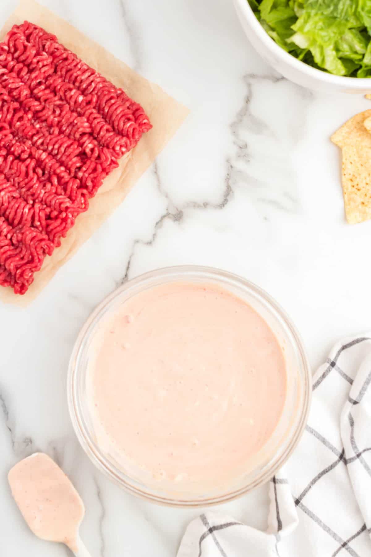 Blended sour cream and salsa in bowl for Taco Salad