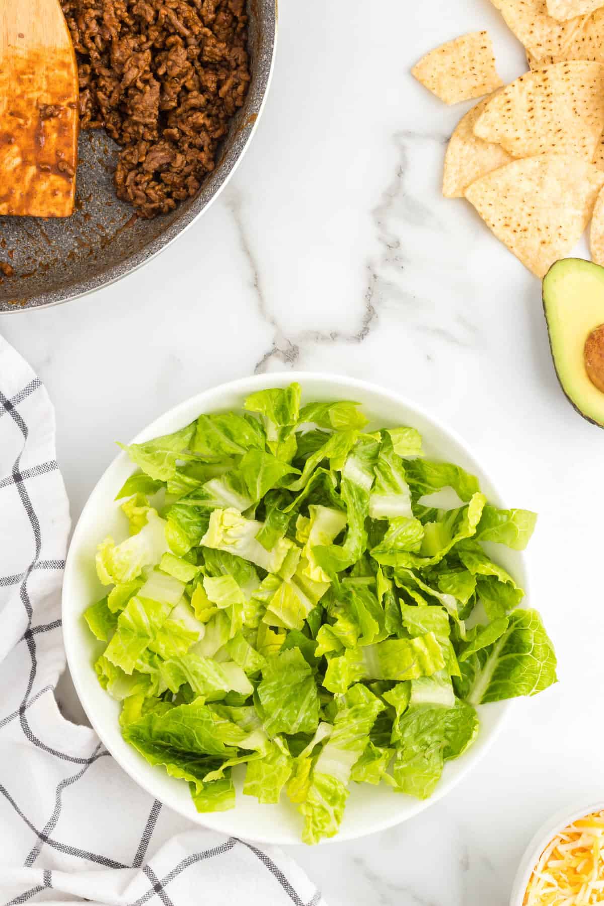 Chopped romaine lettuce in bowl for Easy Taco Salad Recipe