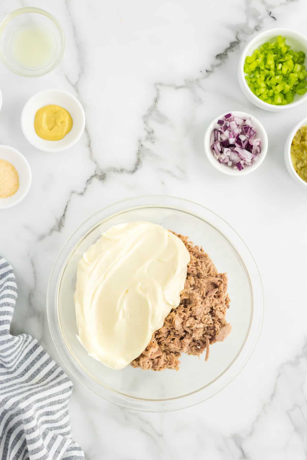 Mixing tuna and mayo in bowl for Tuna Salad Sandwich Recipe