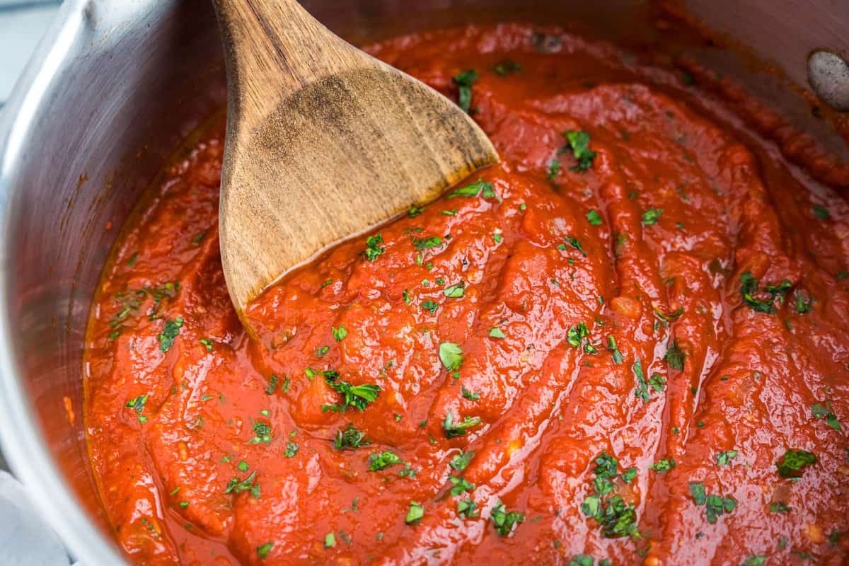 Best Marinara Sauce Recipe in Stovetop Pot Stirred with Wooden Spoon