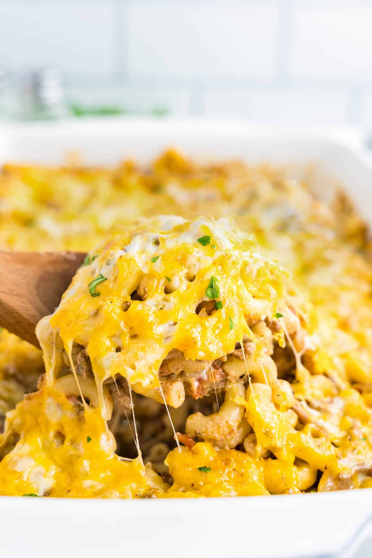 Cheeseburger Casserole Recipe in Baking Dish with Wooden Spoon Scooping