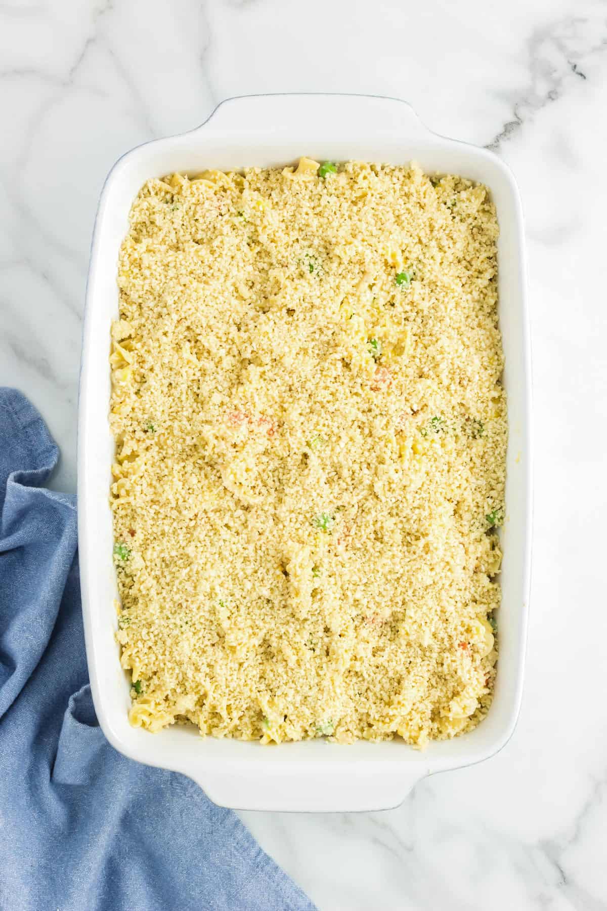 Topping Chicken Noodle Casserole with panko crumbs in 9x13 baking dish