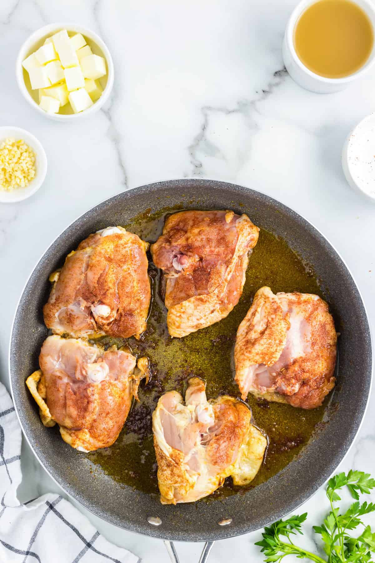 Chicken Thighs in heated oil in stovetop skillet for Slow Cooker Chicken Thighs recipe