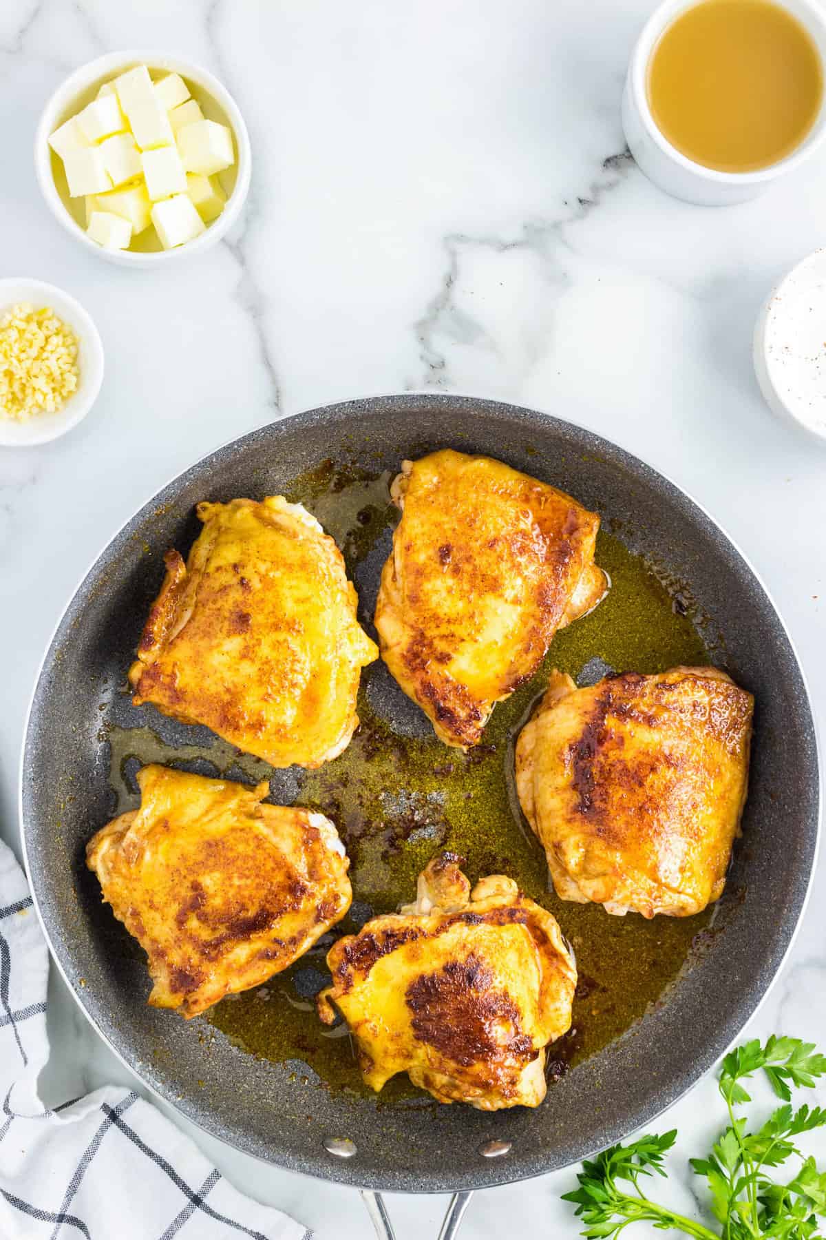 Chicken Thighs in heated oil in stovetop skillet for Slow Cooker Chicken Thighs recipe