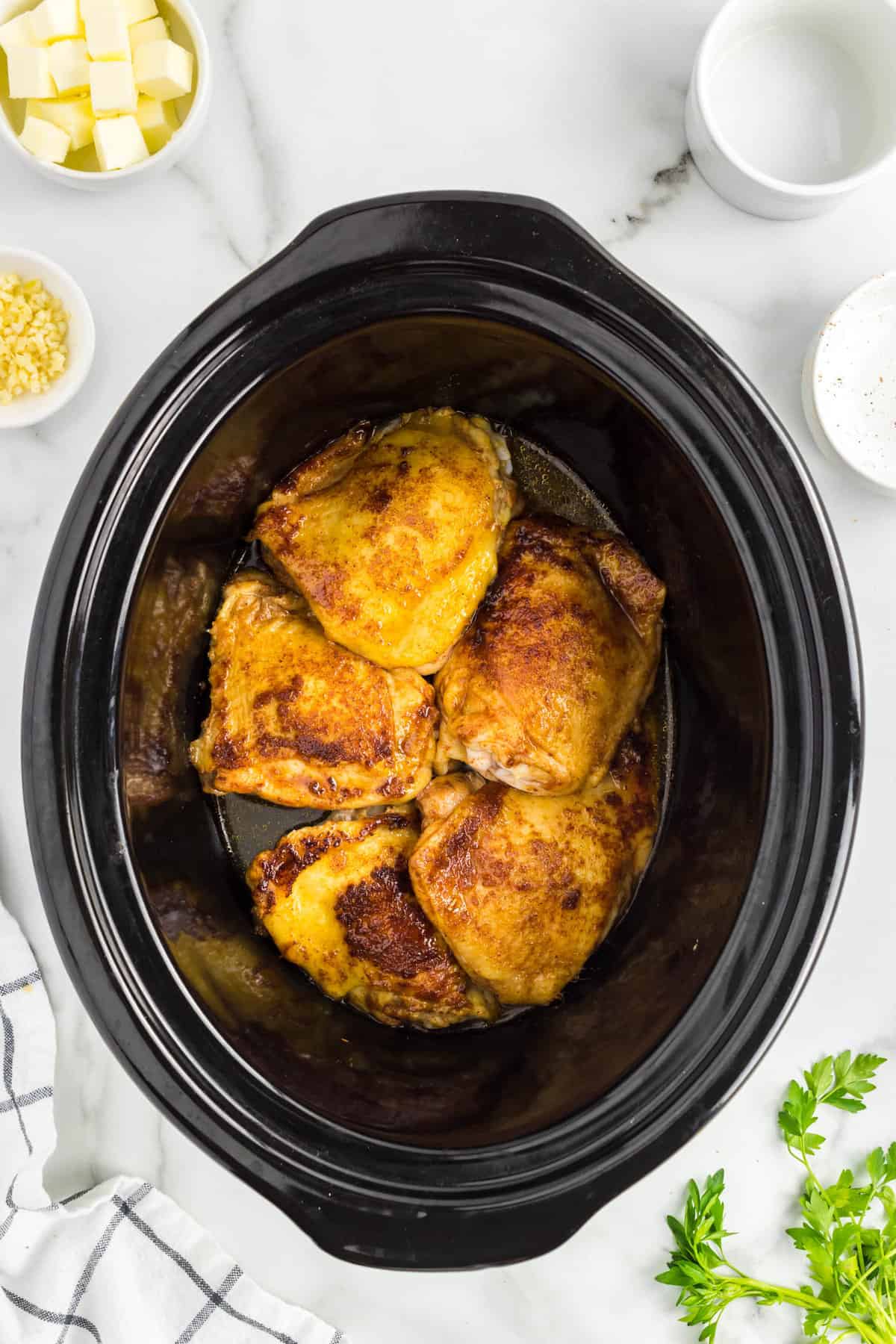 Adding chicken thighs to crock pot for Slow Cooker Chicken Thighs recipe