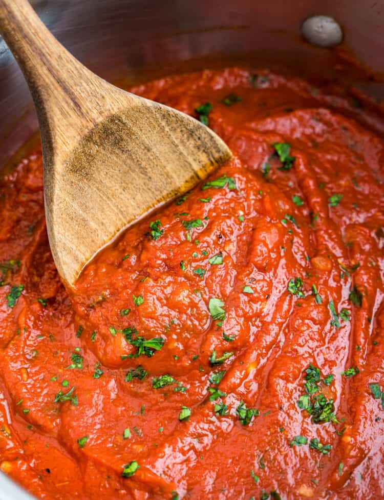 Best Marinara Sauce Recipe in Stovetop Pot Stirred with Wooden Spoon