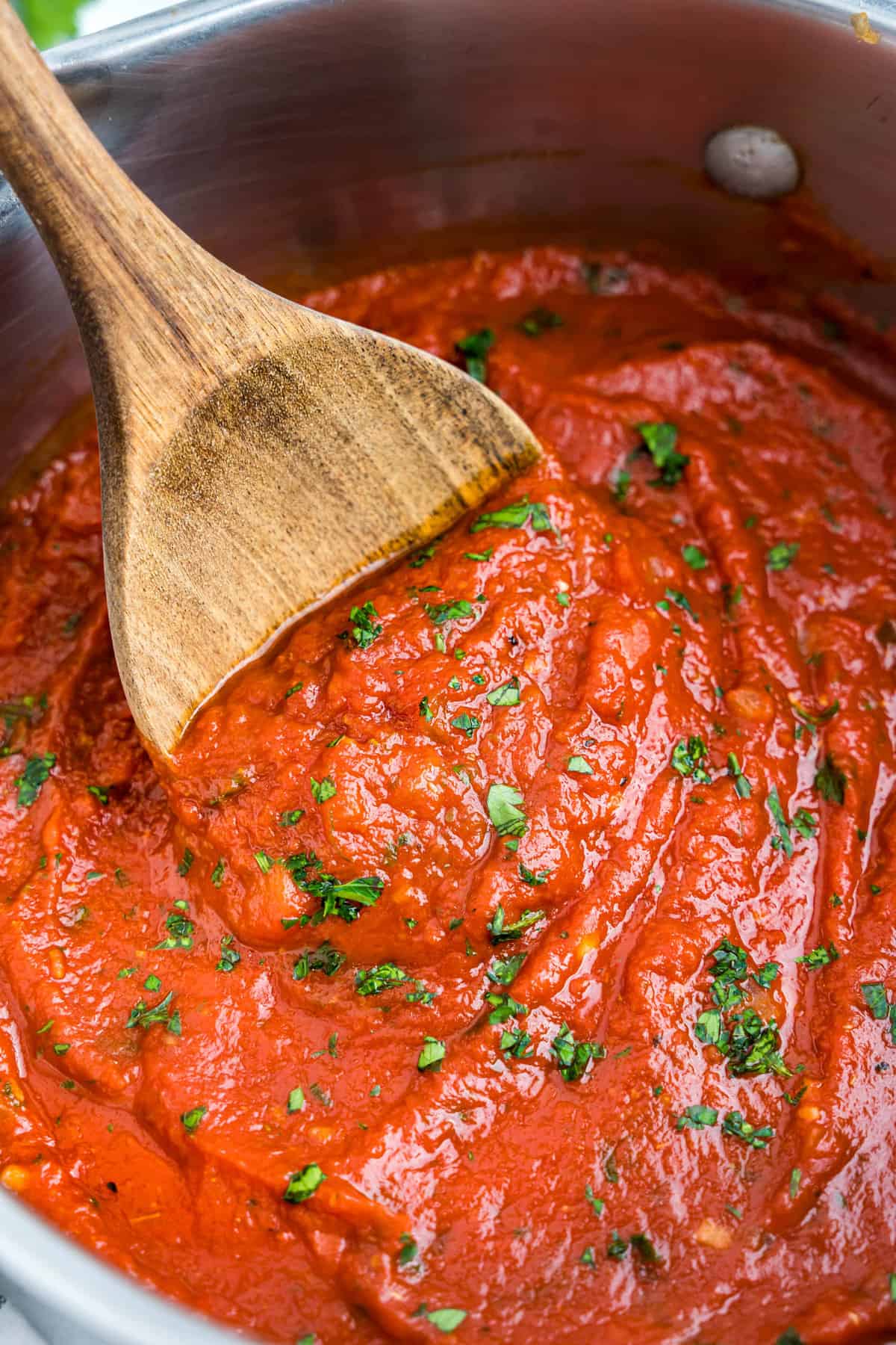 Best Marinara Sauce Recipe in Stovetop Pot Stirred with Wooden Spoon
