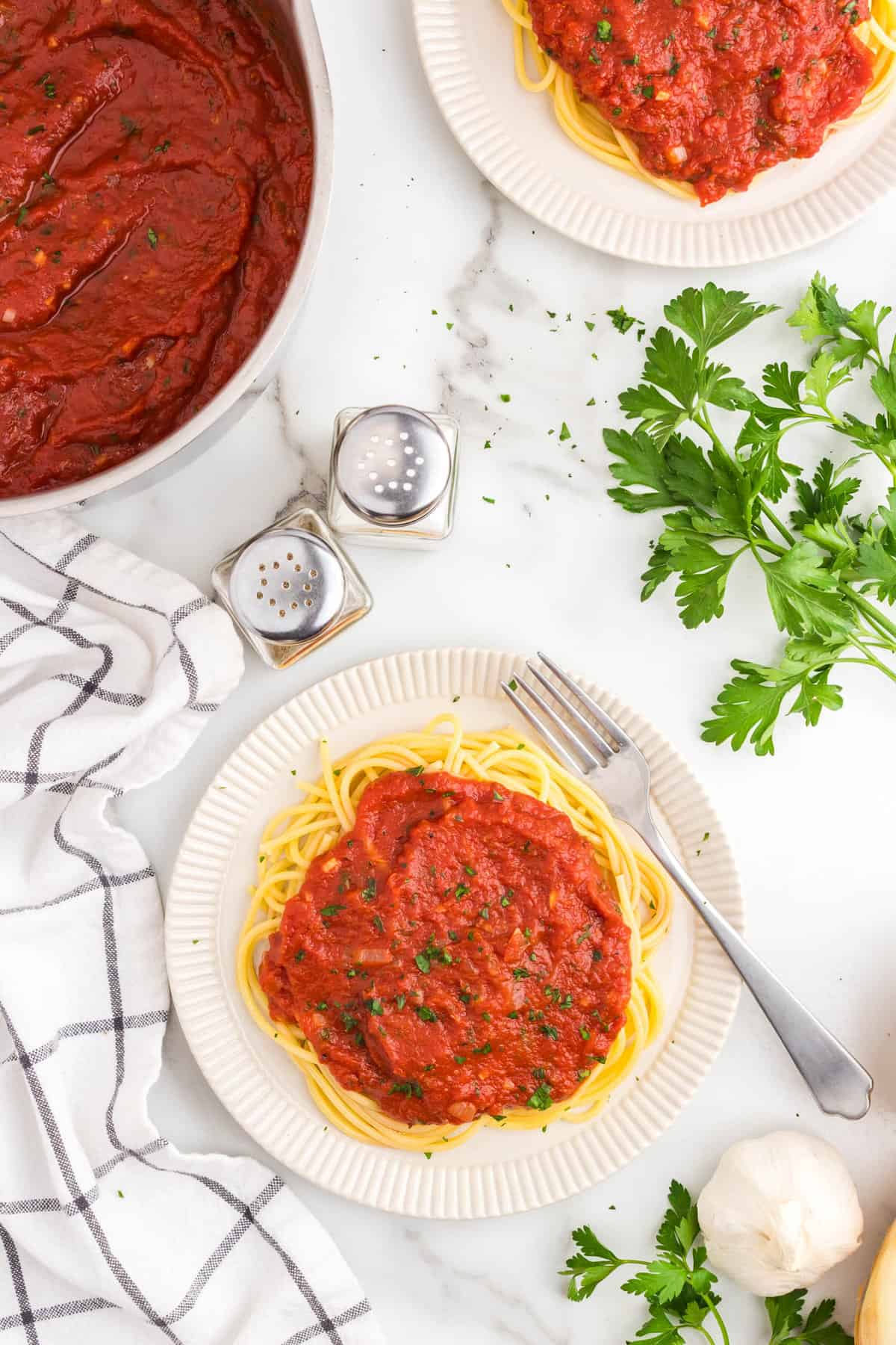 Best Marinara Sauce Recipe atop a bed of spahgetti noodles on plate