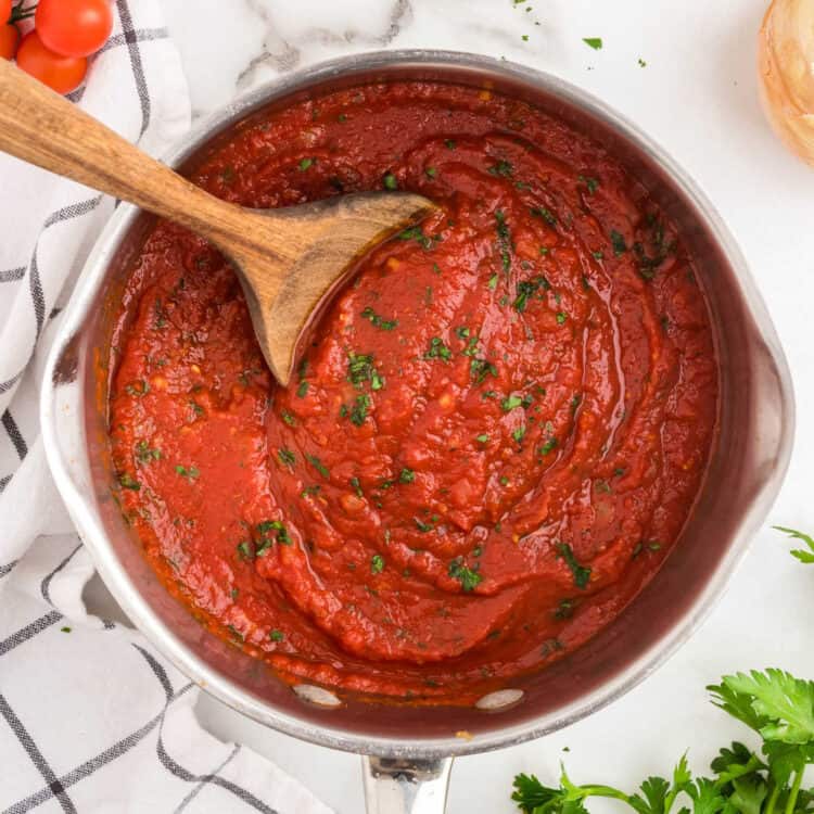 Homemade Marinara Sauce in Stovetop Pot with Wooden Spoon