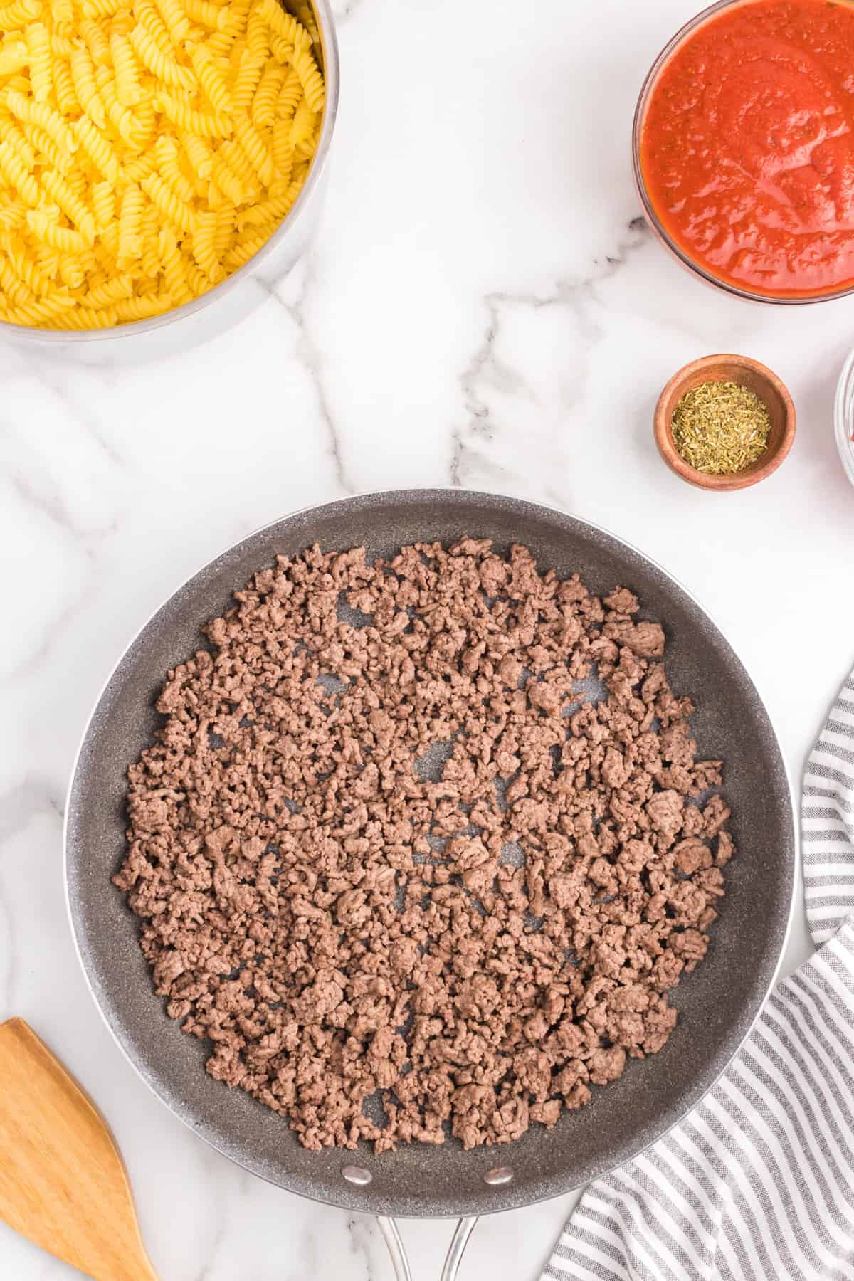 Browing ground beef in stovetop skillet for Pizza Casserole recipe