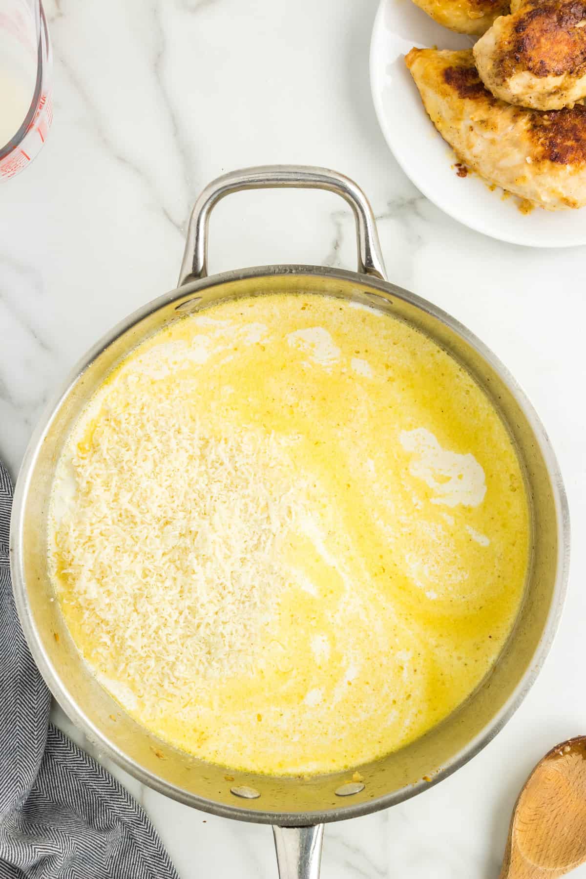 Cream and chicken broth in pan for Marry Me Chicken Recipe