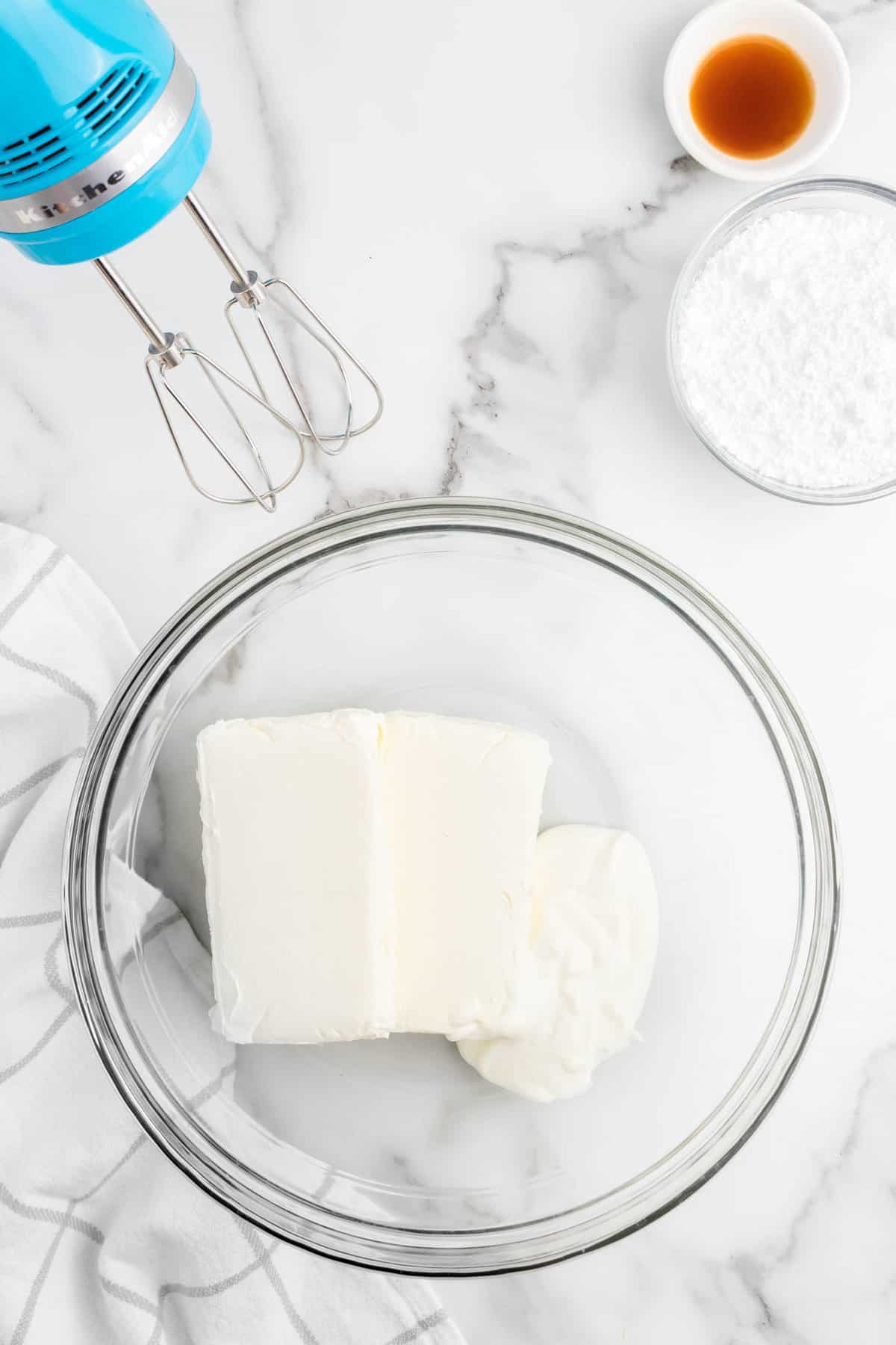 Cream cheese and sour cream in bowl for No Bake Blueberry Cheesecake filling