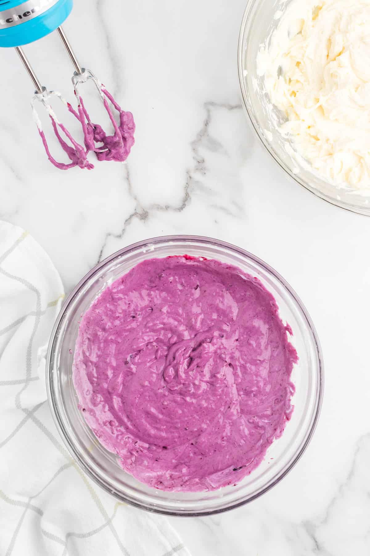 Mixed whipped cream and blueberry mixture in bowl for No Bake Blueberry Cheesecake