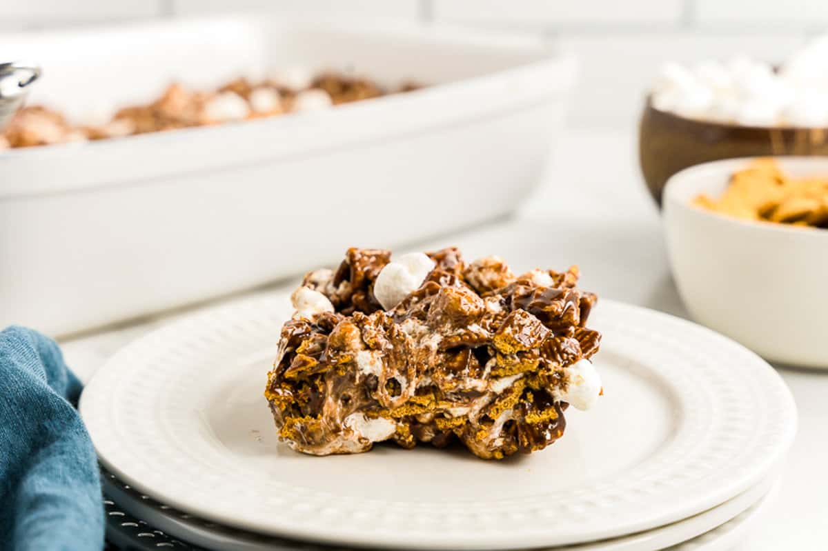 a Bite taken out of a S'mores Bar on a plate.