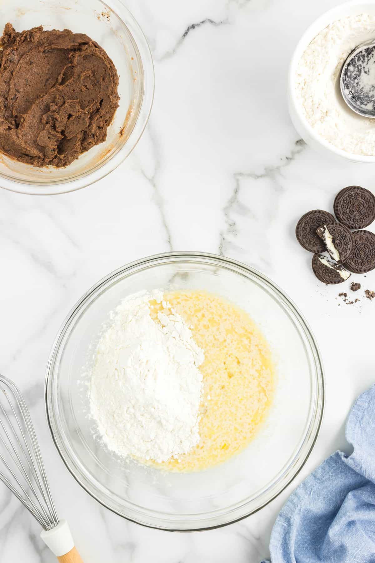 Adding flour to yeast mixture for Oreo Cinnamon Rolls in bowl