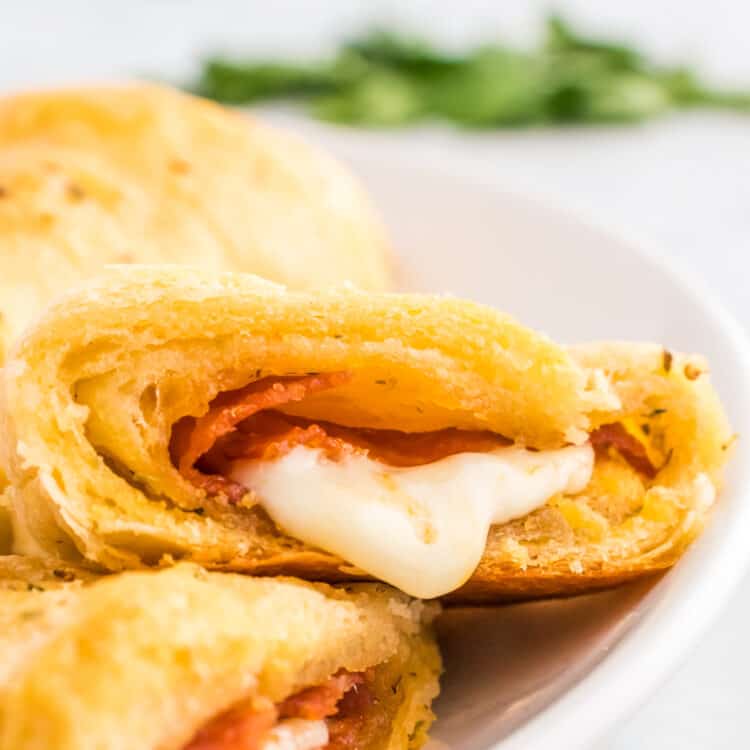 Pizza Crescent Rolls sliced open on white plate