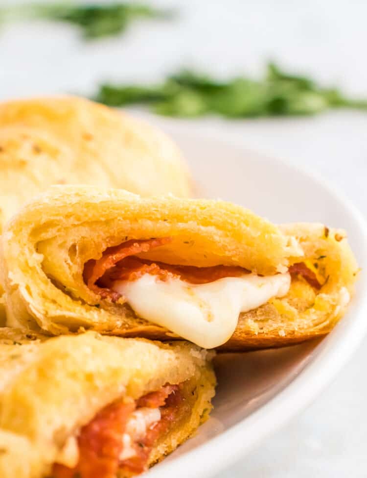 Pizza Crescent Rolls sliced open on white plate