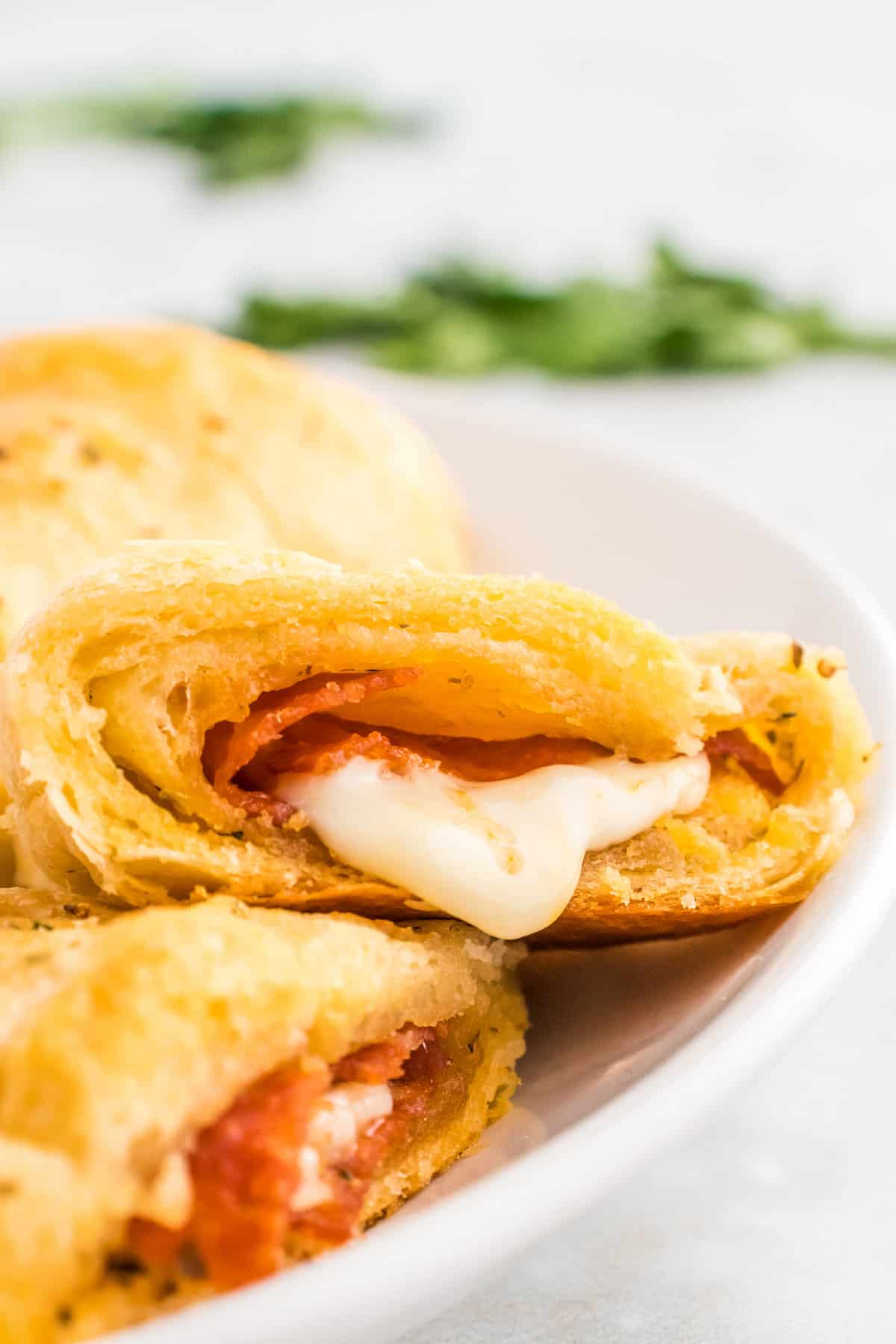 Pizza Crescent Rolls sliced open on white plate