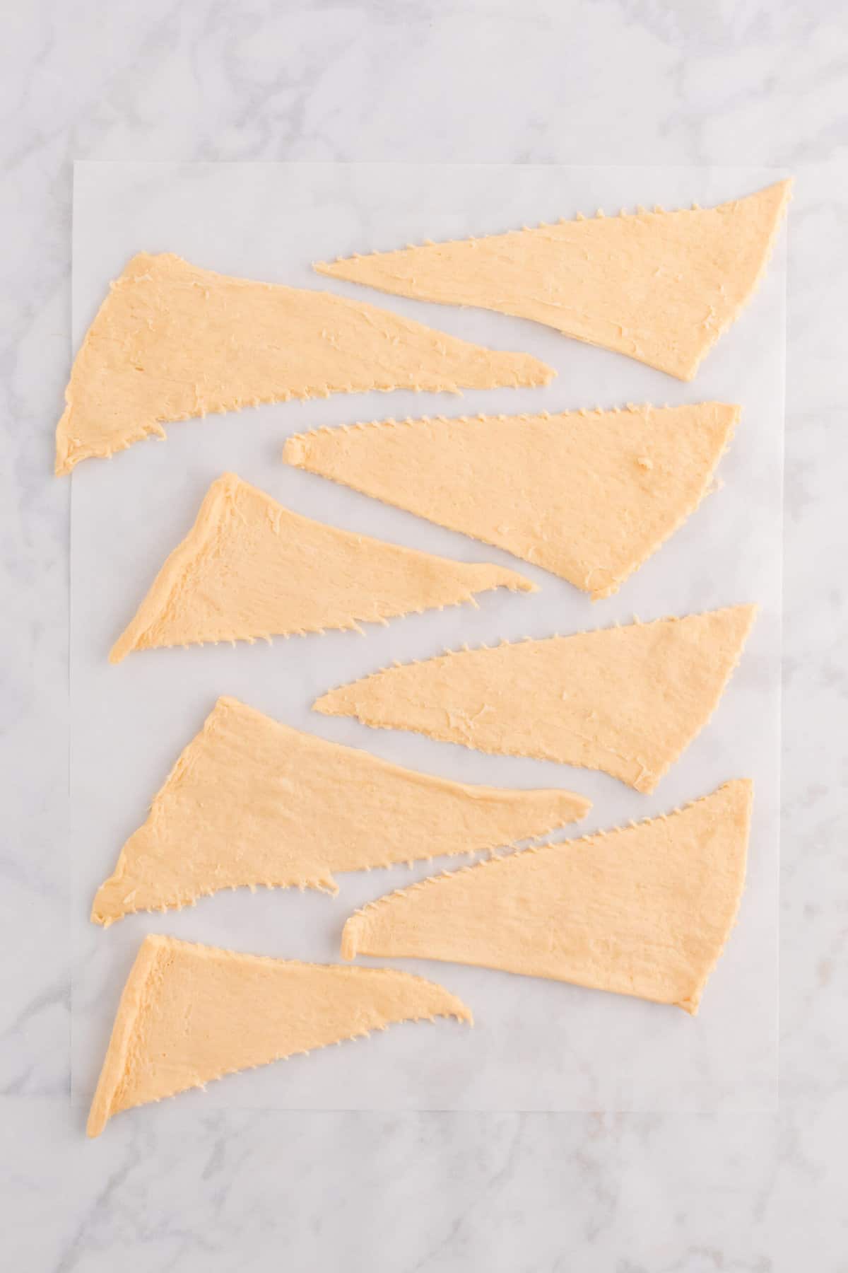 Unroll Crescent rolls and separate on a piece of parchment paper.