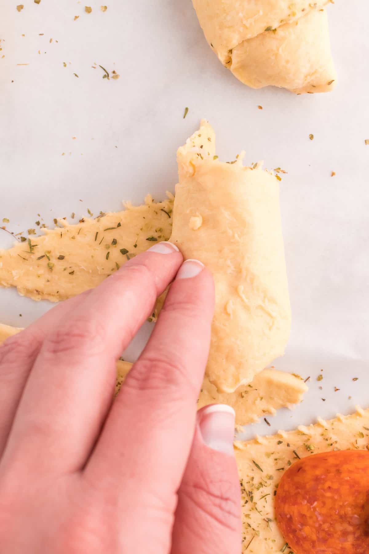 Starting at the widest part of the crescent roll start rolling towards the end and seal the edges together.