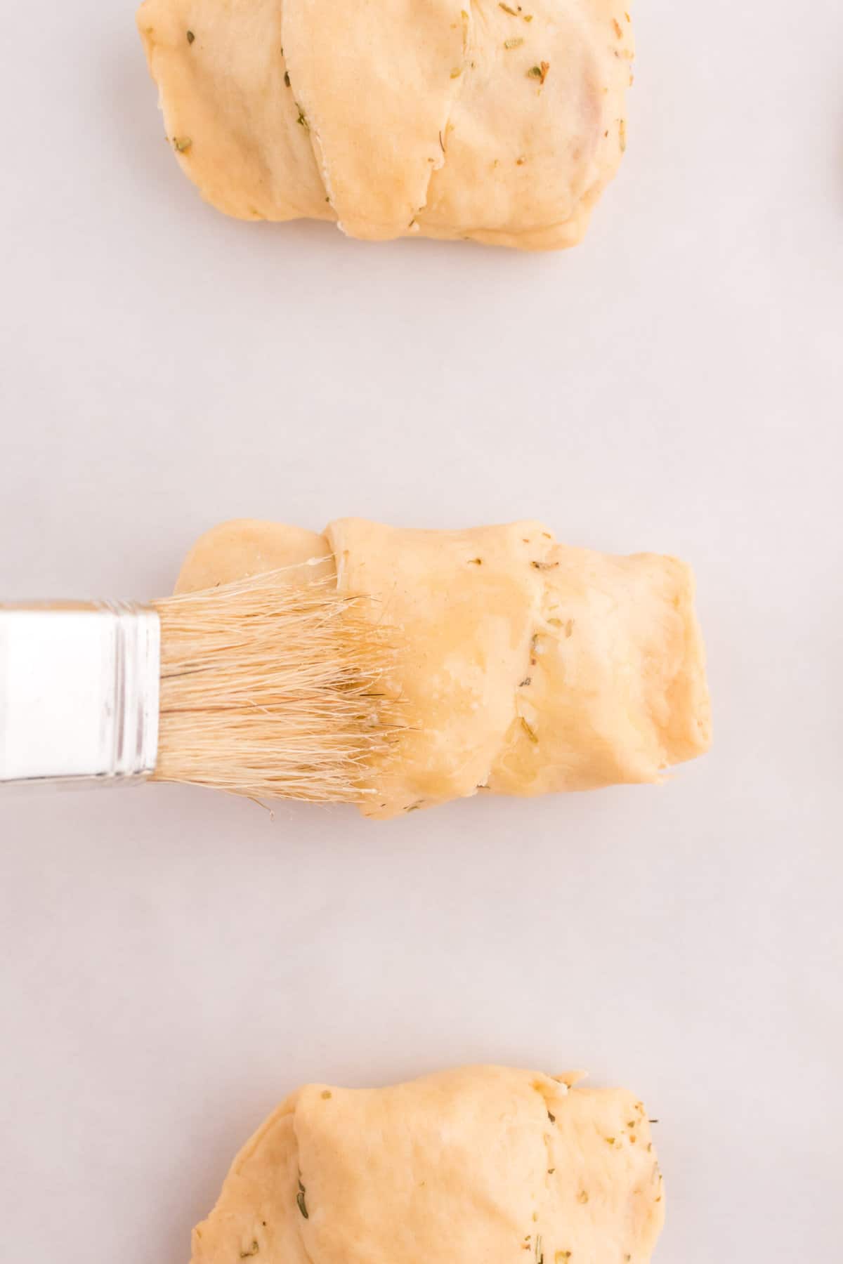 Coat the top of the Crescent Roll with butter and cook.