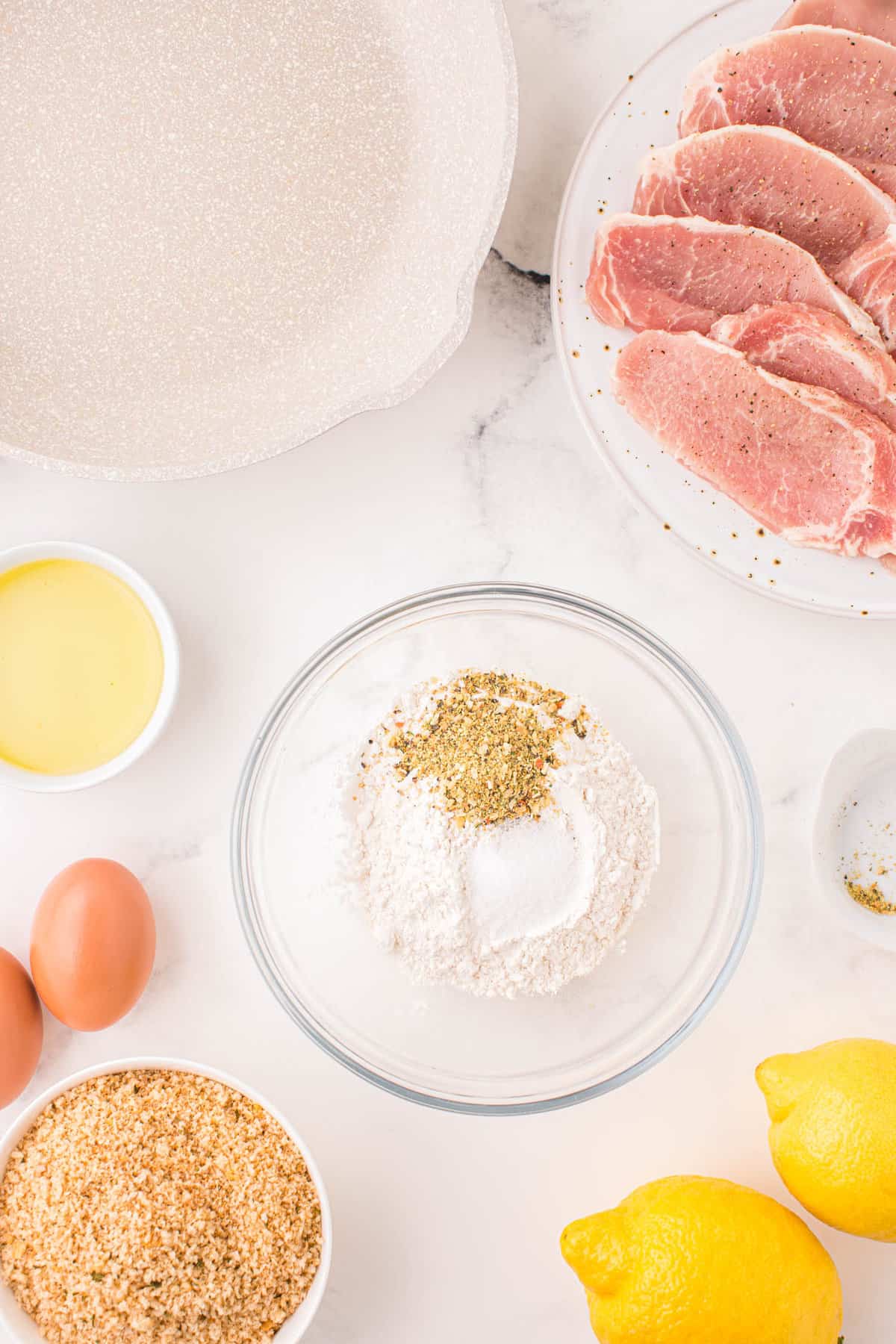 Combining Breading Ingredients in Bowl for Pork Schnitzel Recipe