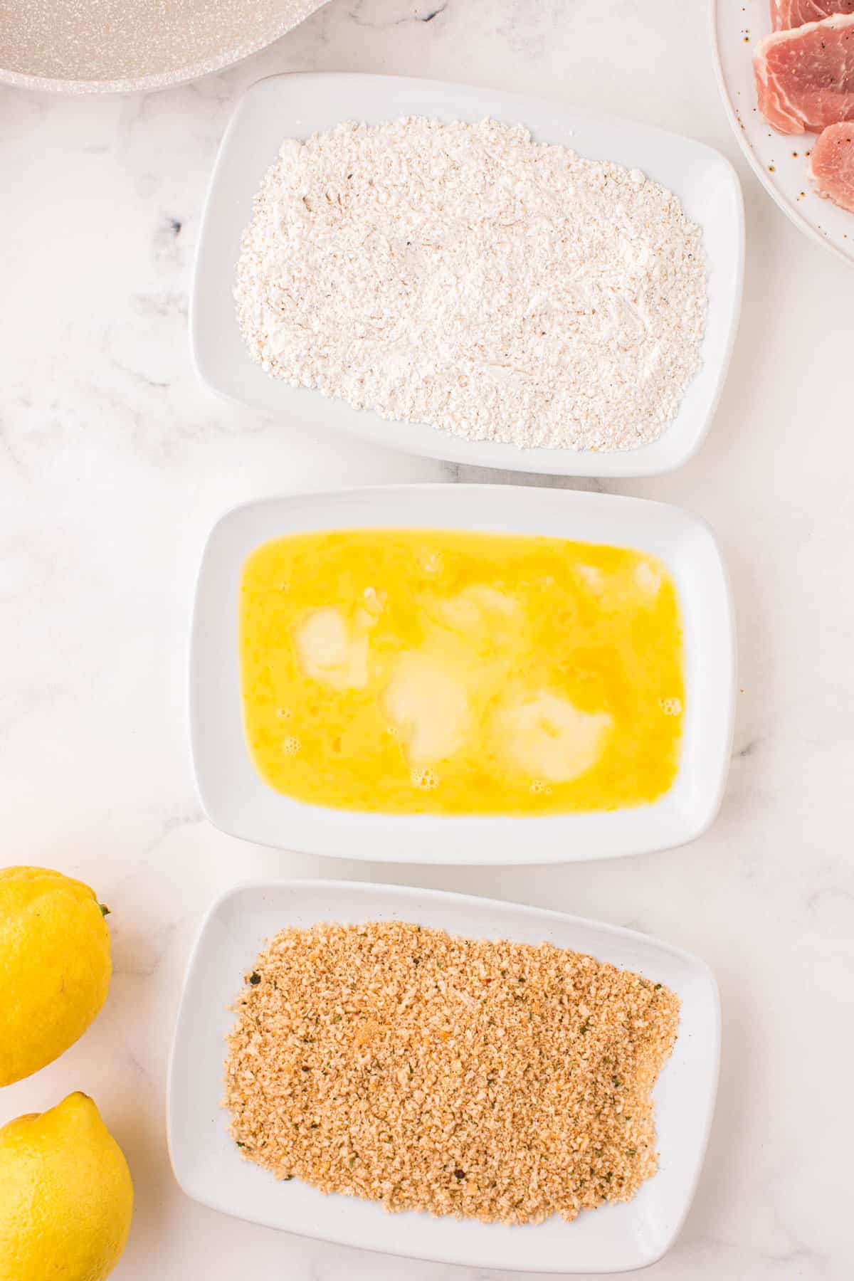 Three Shallow Bowls with  the Breading Mixtures for Pork Schnitzels