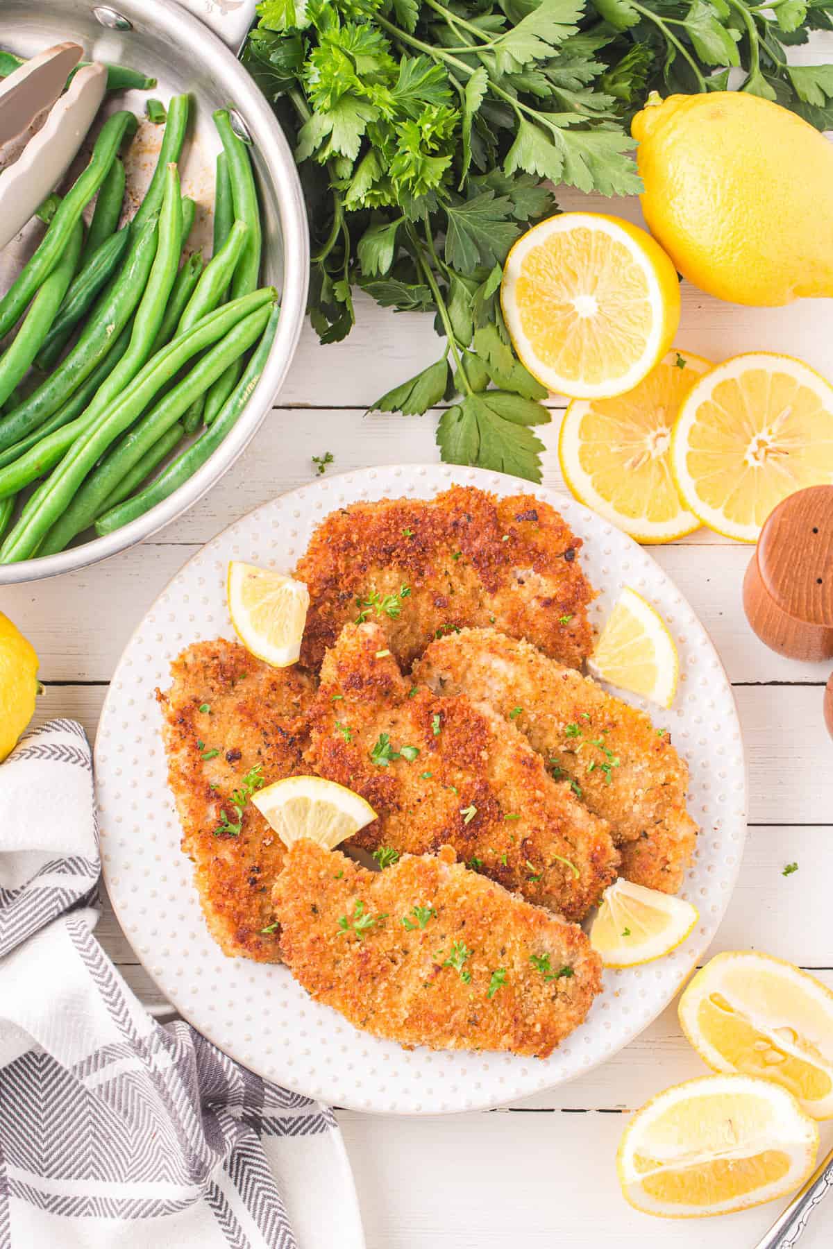 Tender and Juicy Pork Schnitzel Topped with Lemon Wedges
