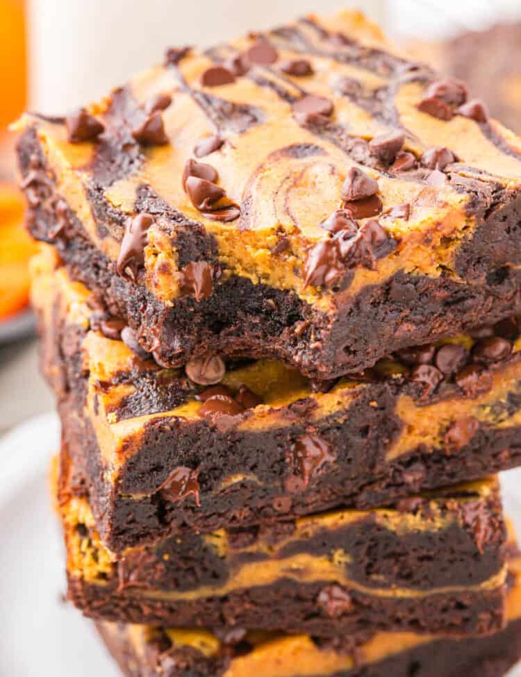 Pumpkin Brownies cut into squares and stacked on plate