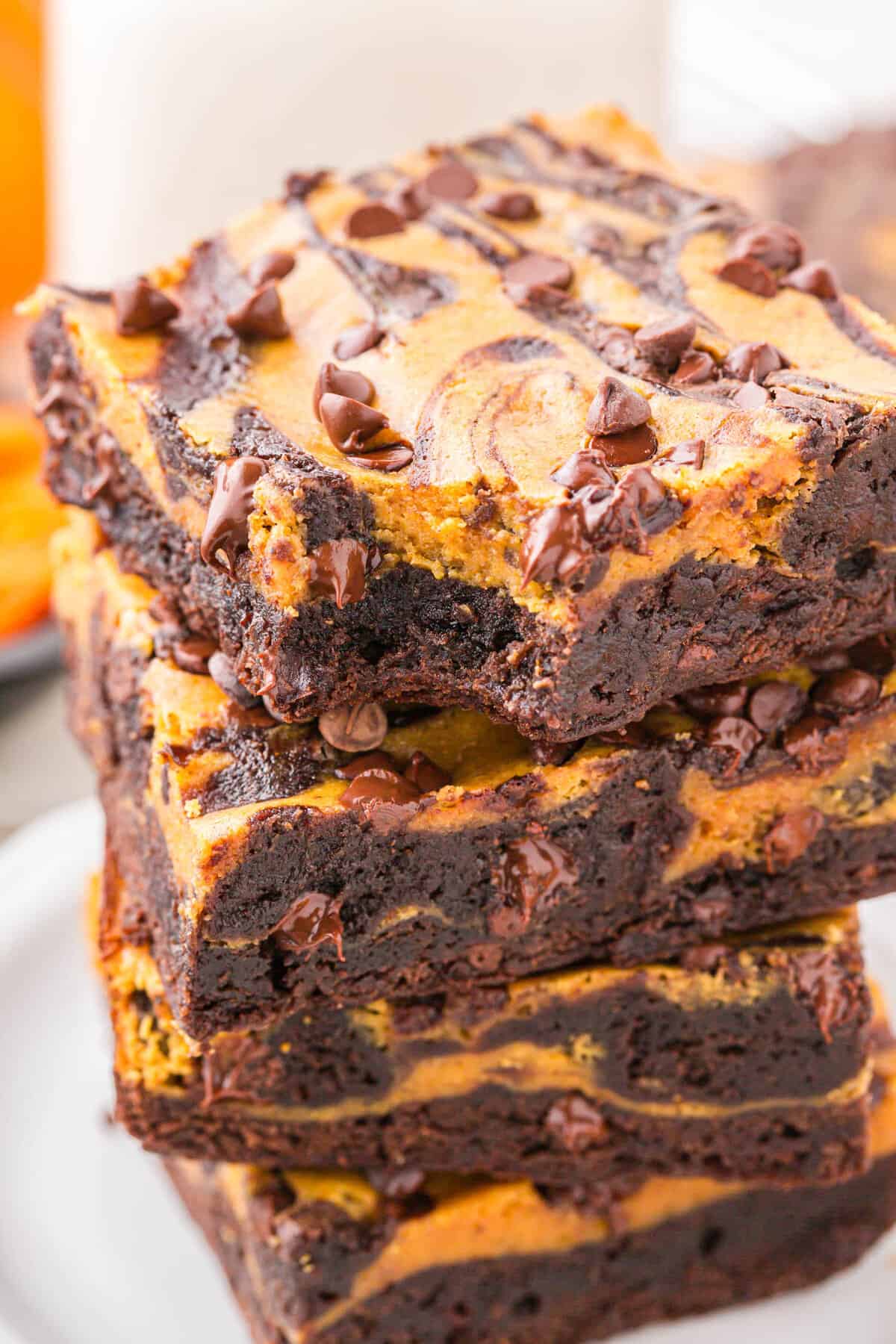 Pumpkin Brownies cut into squares and stacked on plate