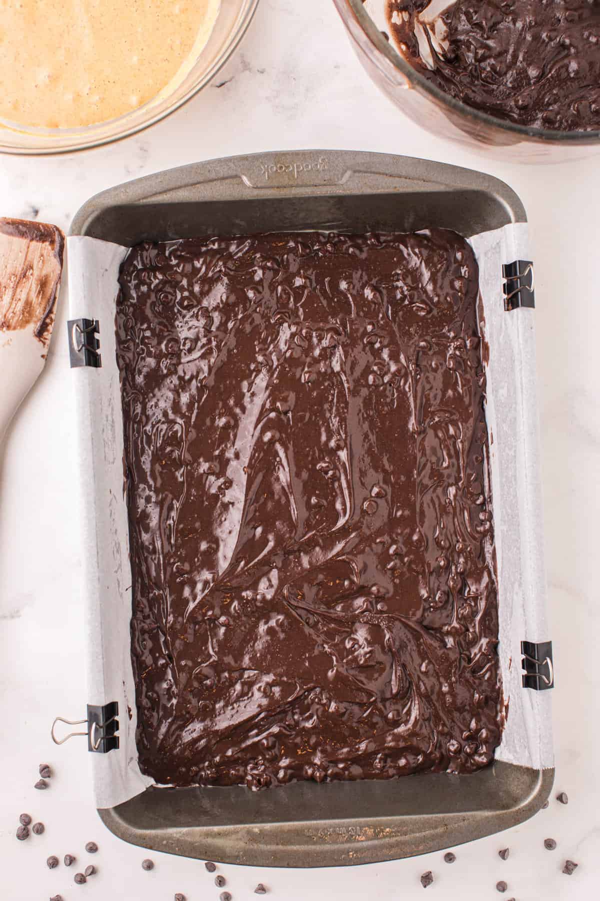 Spreading brownie layer for Pumpkin Brownies Recipe in baking pan