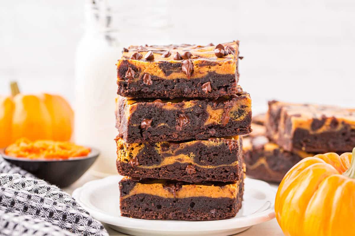Pumpkin Brownies cut into squares and stacked on plate