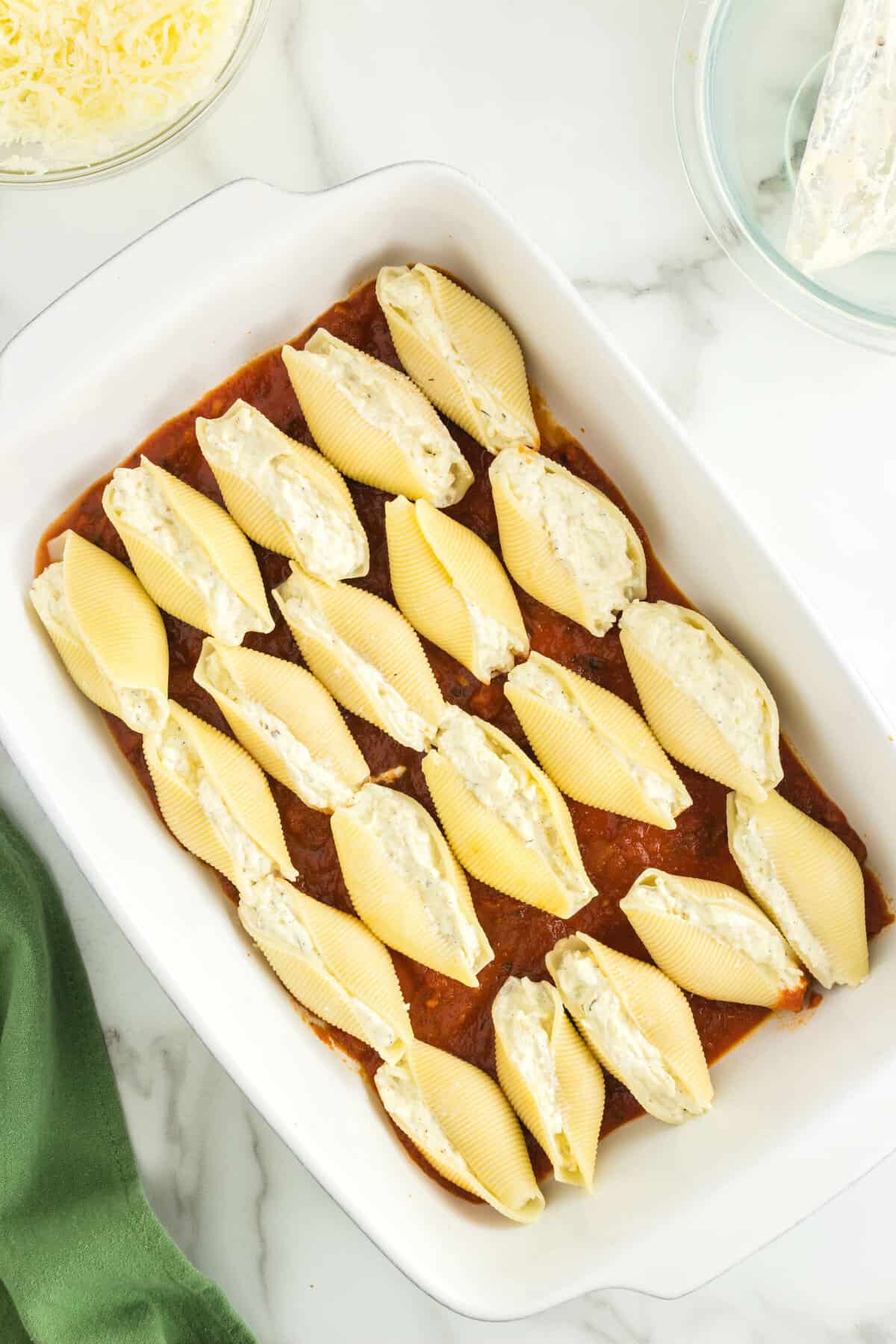 Stuffed Shells Arranged Atop Marinara in Baking Dish