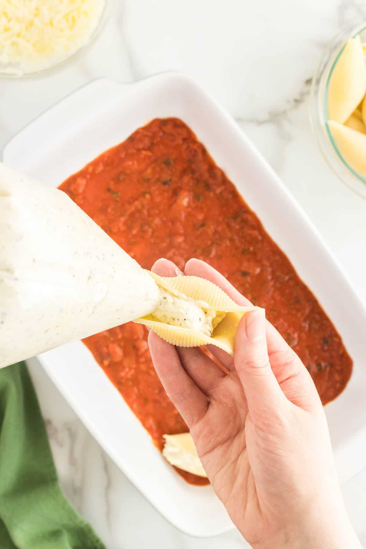 Using Piping Zip Lock Bag to PIpe in Cheese Mixture into Pasta for Stuffed Shells Recipe